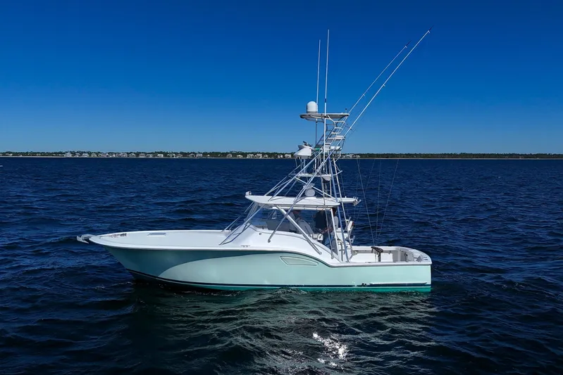 Reel Blessings Yacht Photos Pics 2006 Out Island 38 Express boat on open water under clear blue sky.