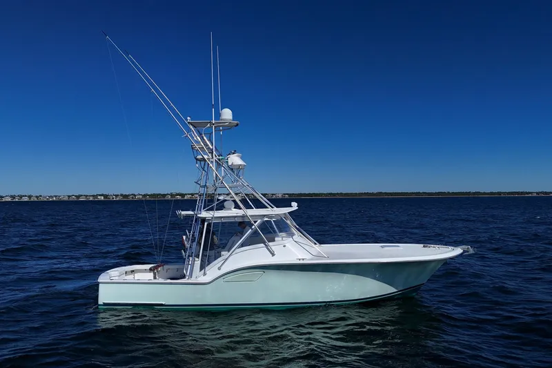 Reel Blessings Yacht Photos Pics 2006 Out Island 38 Express boat on calm blue ocean under clear sky.