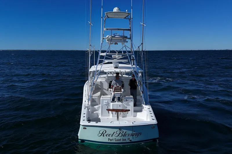 Reel Blessings Yacht Photos Pics 2006 Out Island 38 Express boat on open sea, clear blue sky.