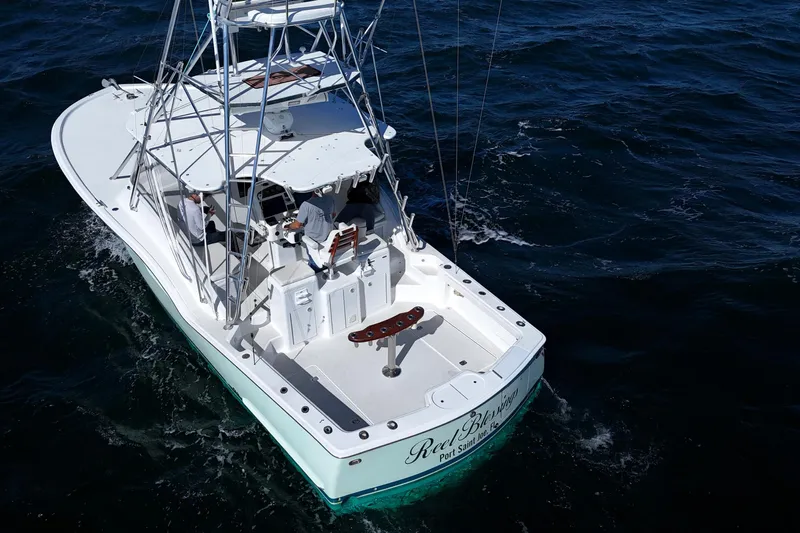 Reel Blessings Yacht Photos Pics 2006 Out Island 38 Express boat cruising on open water, aerial view.