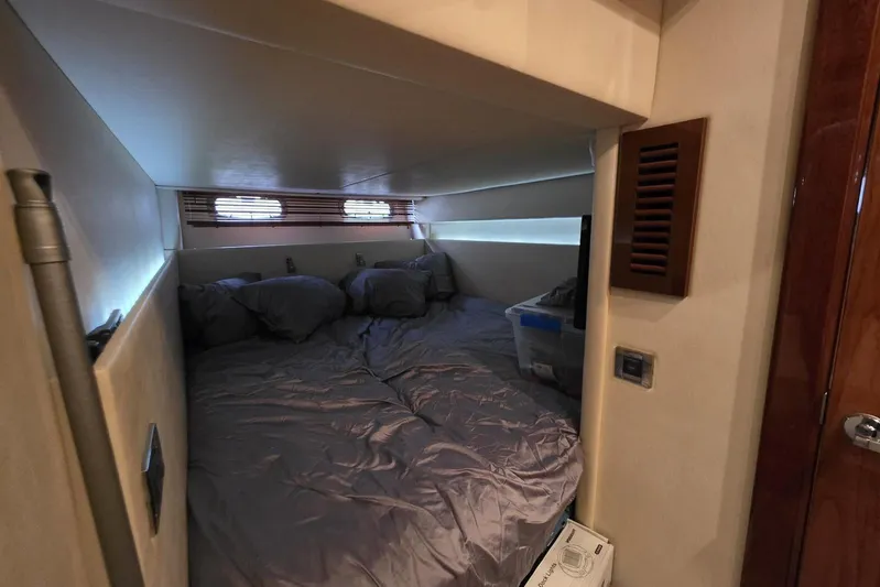  Yacht Photos Pics Cozy cabin interior of 2010 Sea Ray 470 Sundancer yacht with bed and porthole windows.