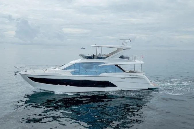  Yacht Photos Pics 2023 Absolute 62 Fly yacht cruising on calm ocean waters.