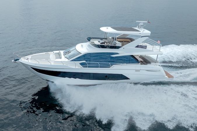 2023 Absolute 62 Fly yacht cruising on open water, showcasing sleek design and luxury features.