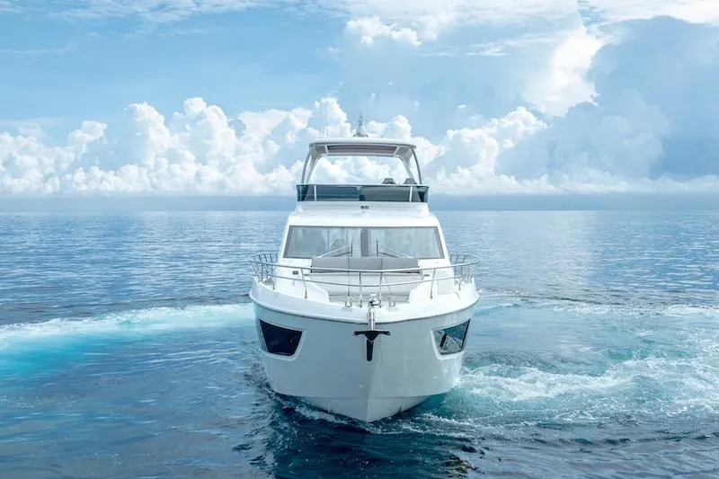  Yacht Photos Pics 2023 Absolute 62 Fly yacht cruising on open sea under cloudy sky.