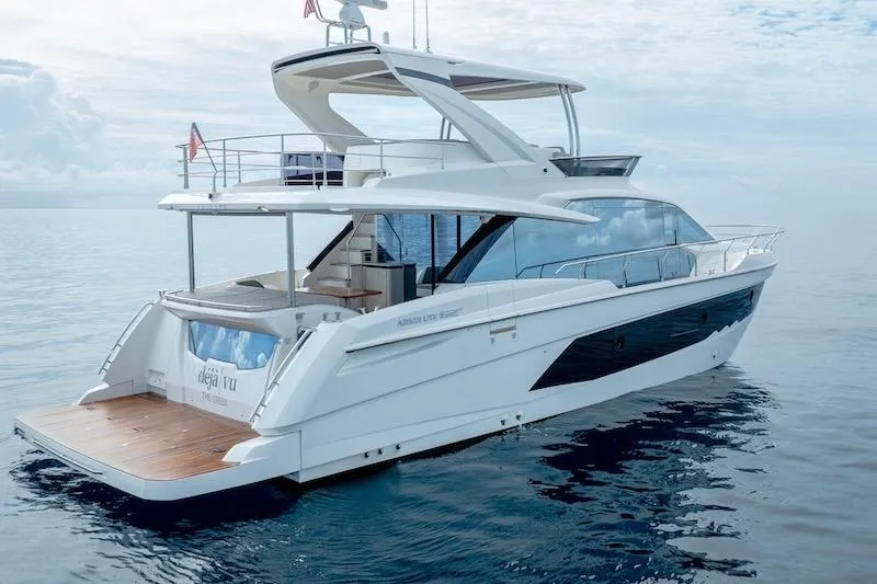  Yacht Photos Pics 2023 Absolute 62 Fly yacht on calm ocean waters, showcasing sleek design and luxury features.