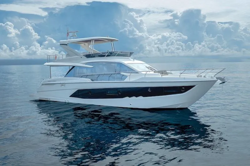  Yacht Photos Pics 2023 Absolute 62 Fly yacht on calm ocean under cloudy sky.