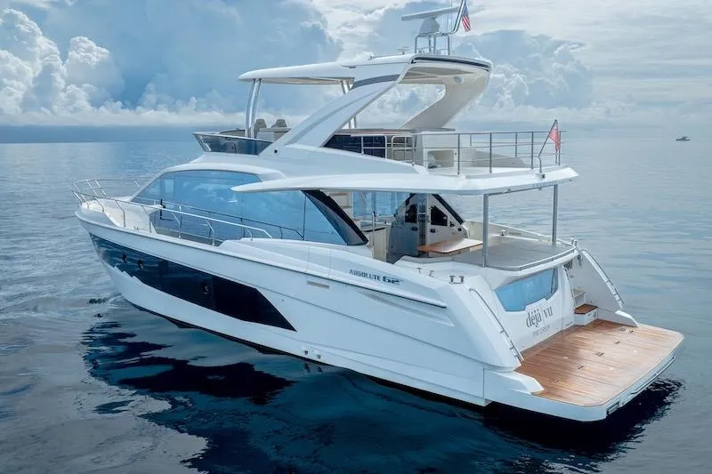 Yacht Photos Pics 2023 Absolute 62 Fly yacht on calm ocean waters under cloudy sky.