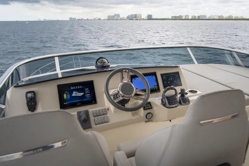  Yacht Photos Pics 2023 Absolute 62 Fly yacht helm with modern navigation systems, steering wheel, and ocean view.
