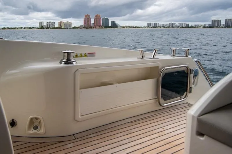  Yacht Photos Pics 2023 Absolute 62 Fly yacht deck with city skyline in background.