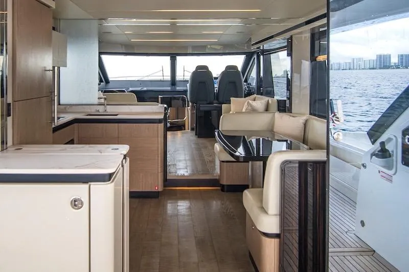  Yacht Photos Pics Luxurious interior of 2023 Absolute 62 Fly yacht with modern furnishings and panoramic windows.