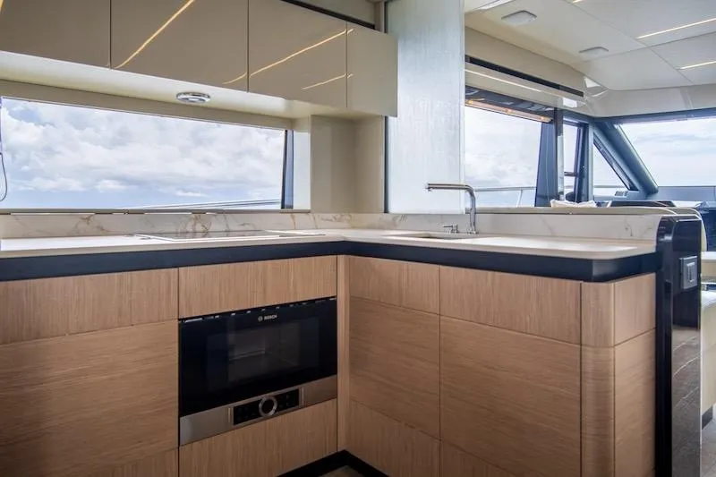  Yacht Photos Pics Luxurious kitchen interior of 2023 Absolute 62 Fly yacht with modern appliances and ocean view.