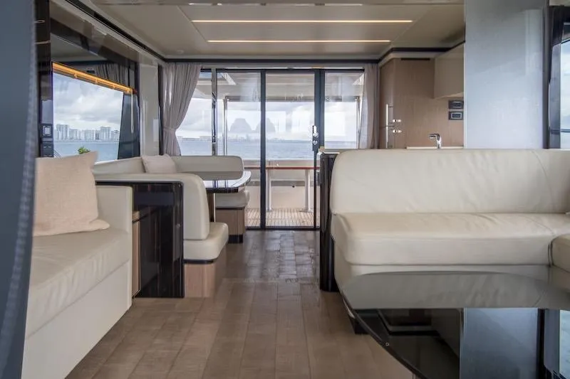  Yacht Photos Pics Luxurious interior of 2023 Absolute 62 Fly yacht with elegant seating and ocean view.