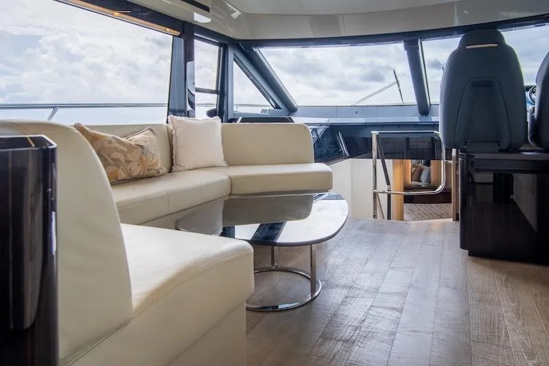  Yacht Photos Pics Luxurious interior of 2023 Absolute 62 Fly yacht with modern seating and panoramic windows.