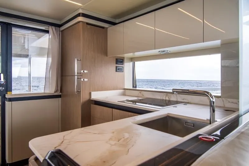  Yacht Photos Pics Luxurious kitchen interior of 2023 Absolute 62 Fly yacht with ocean view.