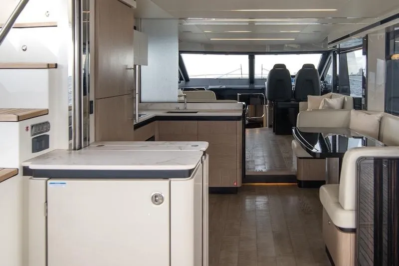  Yacht Photos Pics Luxurious interior of 2023 Absolute 62 Fly yacht with modern kitchen and seating area.