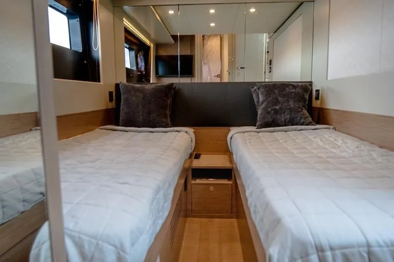  Yacht Photos Pics Luxurious twin cabin interior of 2023 Absolute 62 Fly yacht, featuring modern design and cozy bedding.