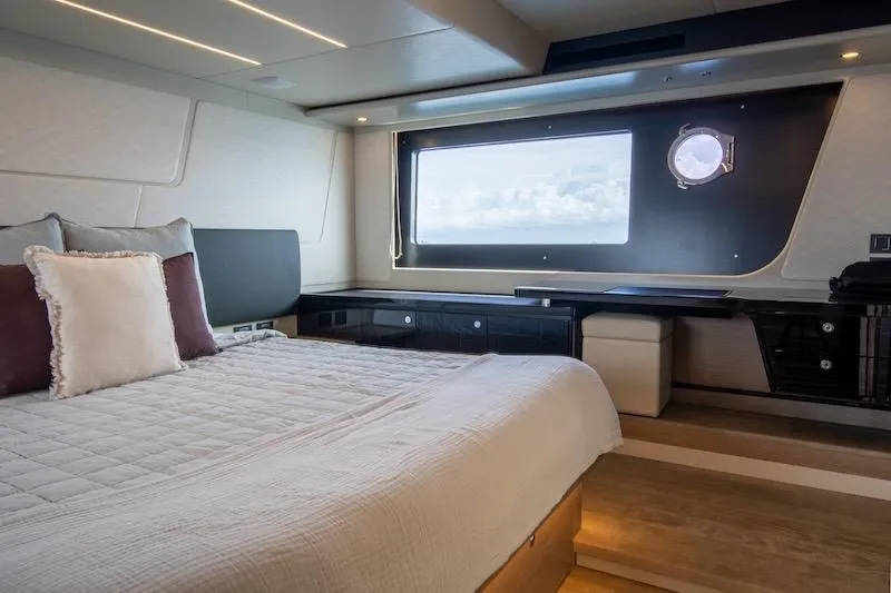  Yacht Photos Pics Luxurious bedroom interior of 2023 Absolute 62 Fly yacht with ocean view window.