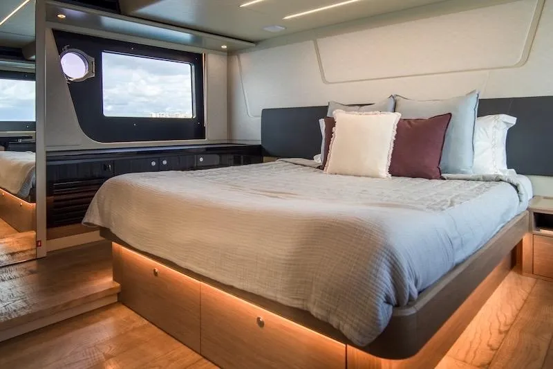  Yacht Photos Pics Luxurious bedroom interior of 2023 Absolute 62 Fly yacht with modern design and cozy bedding.