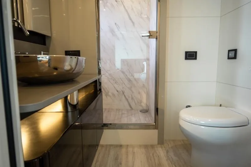  Yacht Photos Pics Luxurious bathroom in 2023 Absolute 62 Fly yacht with modern fixtures and elegant design.
