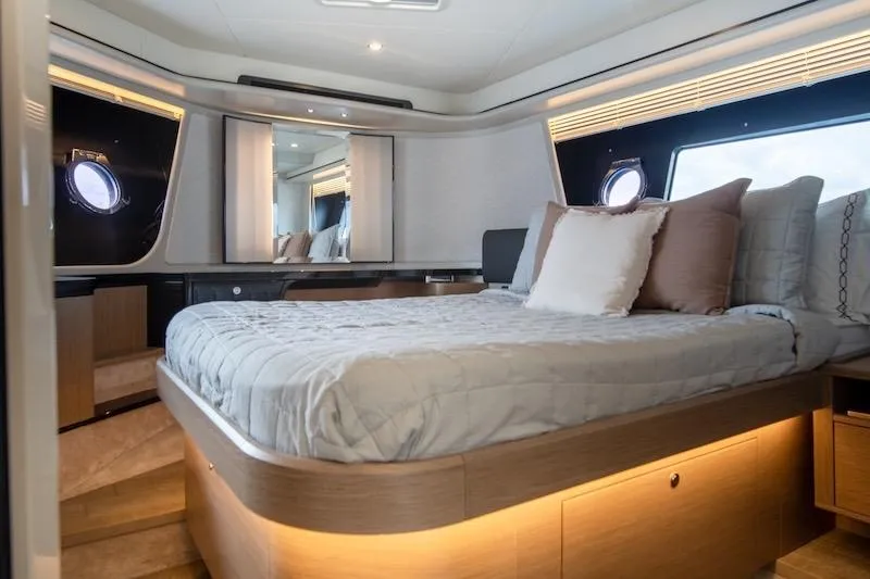  Yacht Photos Pics Luxurious bedroom interior of 2023 Absolute 62 Fly yacht with modern design and ambient lighting.