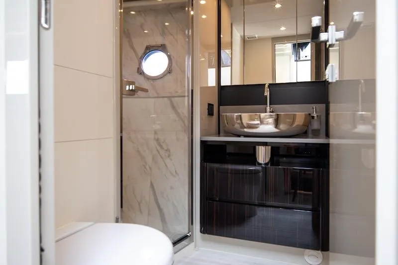  Yacht Photos Pics Luxurious bathroom in 2023 Absolute 62 Fly yacht with modern fixtures and elegant design.