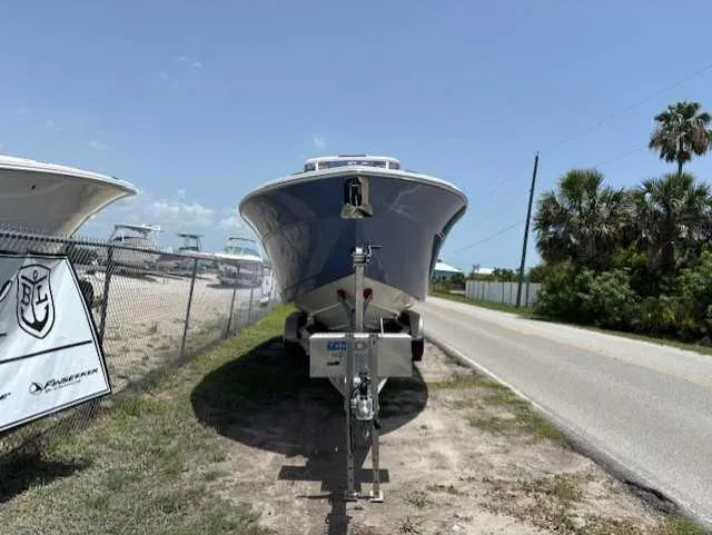 Black Label Marine Yacht Photos Pics 2025 Sea Fox 328 Commander boat on trailer, parked beside a road under clear blue sky.