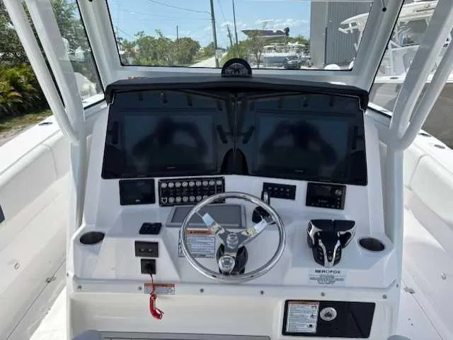 Black Label Marine Yacht Photos Pics 2025 Sea Fox 328 Commander boat dashboard with dual screens and steering wheel.
