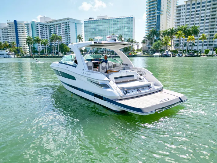  Yacht Photos Pics 2017 Four Winns H350 boat on water with cityscape background.