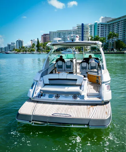  Yacht Photos Pics 2017 Four Winns H350 boat on water with city skyline background.
