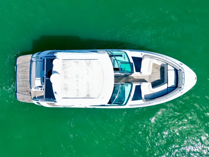  Yacht Photos Pics Aerial view of 2017 Four Winns H350 boat on vibrant green water.