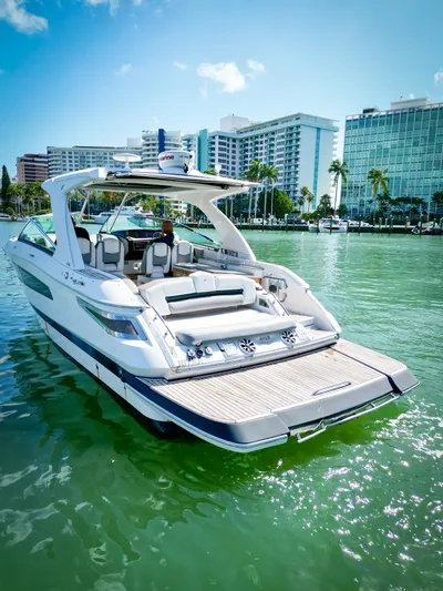  Yacht Photos Pics 2017 Four Winns H350 boat docked in a sunny marina with cityscape background.