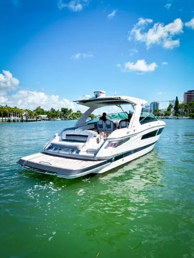  Yacht Photos Pics 2017 Four Winns H350 boat cruising on a sunny day in a scenic waterway.