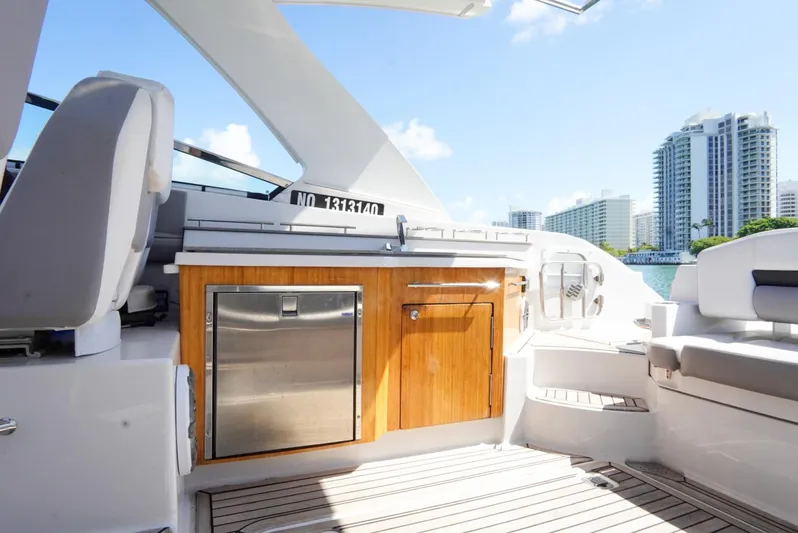  Yacht Photos Pics 2017 Four Winns H350 yacht interior with seating and cabinetry, city skyline in background.