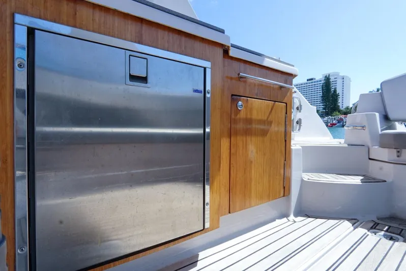  Yacht Photos Pics 2017 Four Winns H350 boat interior with wooden cabinetry and stainless steel appliance.