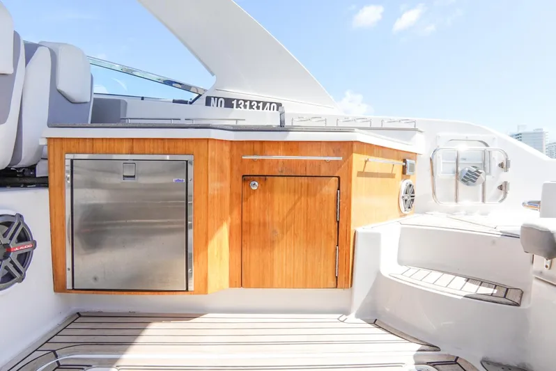  Yacht Photos Pics 2017 Four Winns H350 boat interior with wooden cabinetry and stainless steel appliances.