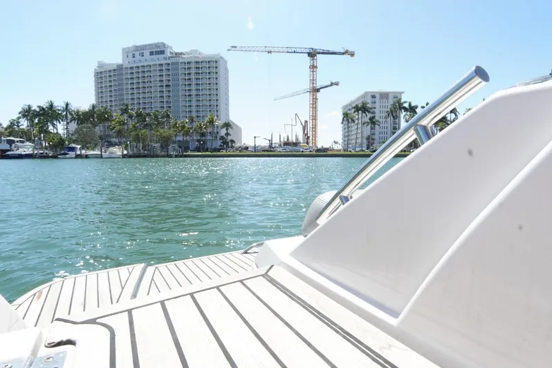  Yacht Photos Pics 2017 Four Winns H350 boat on water with cityscape and cranes in background.