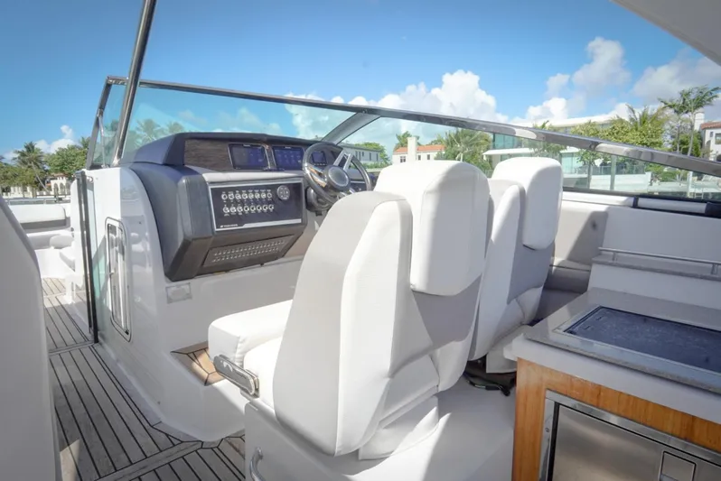  Yacht Photos Pics 2017 Four Winns H350 boat cockpit with white seats and modern dashboard.