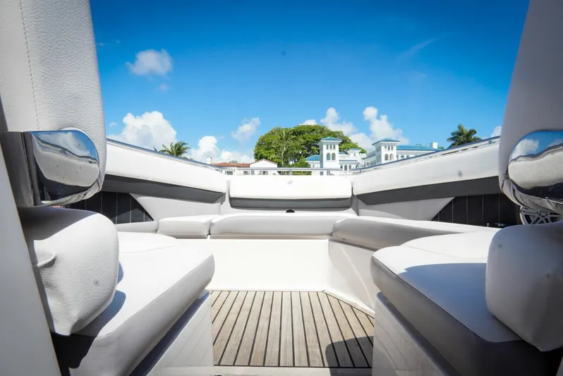  Yacht Photos Pics 2017 Four Winns H350 boat interior with white seating and wooden flooring under a clear blue sky.