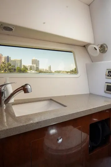  Yacht Photos Pics 2017 Four Winns H350 yacht interior with sink and cityscape view through window.
