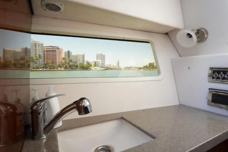  Yacht Photos Pics Interior view of 2017 Four Winns H350 boat with cityscape through window.