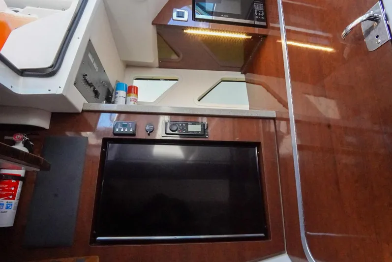  Yacht Photos Pics Interior of 2017 Four Winns H350 boat with TV, microwave, and control panel.
