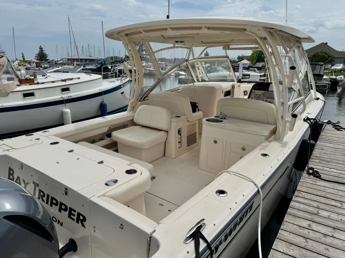 Bay Tripper Yacht Photos Pics 2019 Grady-White Freedom 307 boat docked at marina, featuring spacious seating and sleek design.