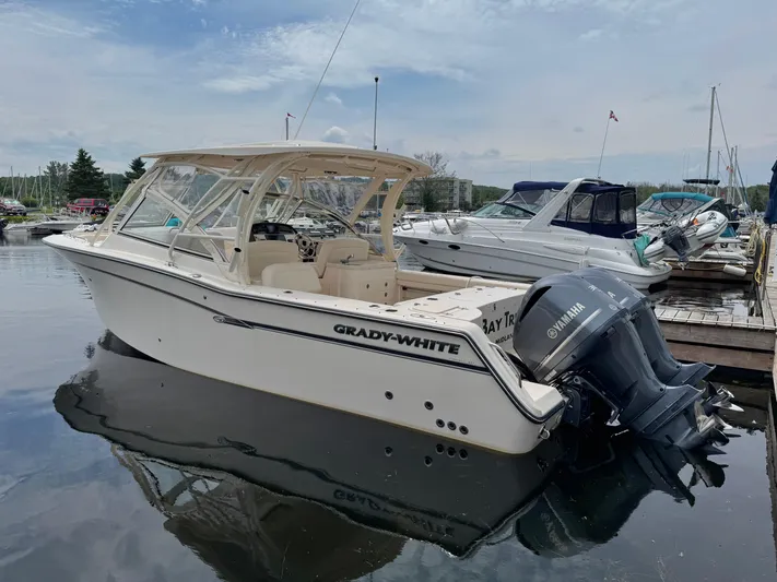 Bay Tripper Yacht Photos Pics 2019 Grady-White Freedom 307 boat docked with Yamaha engines, under a cloudy sky.