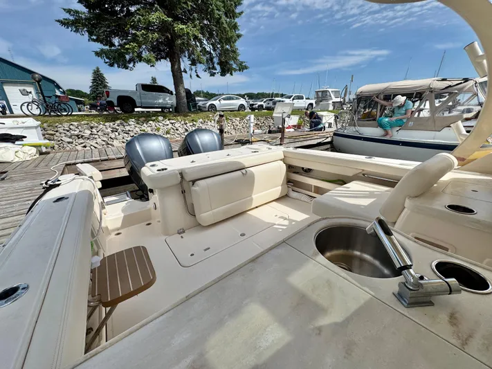 Bay Tripper Yacht Photos Pics 2019 Grady-White Freedom 307 boat docked, featuring dual engines and spacious seating.