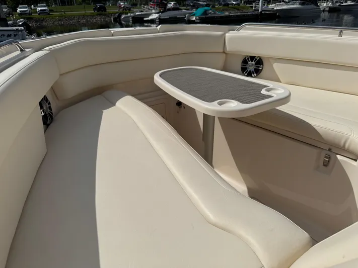 Bay Tripper Yacht Photos Pics 2019 Grady-White Freedom 307 boat interior with cushioned seating and table.
