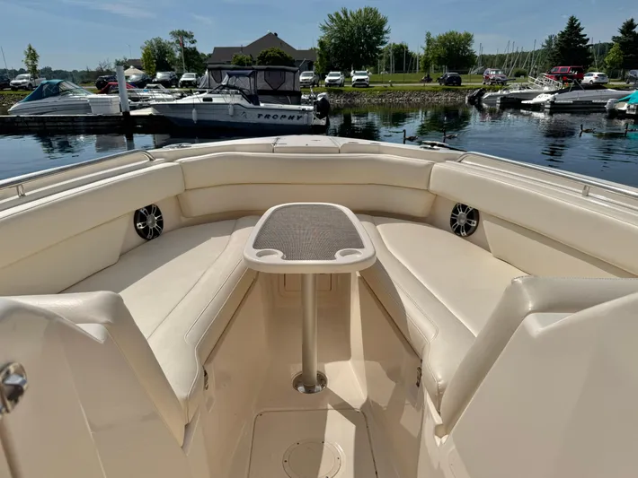 Bay Tripper Yacht Photos Pics 2019 Grady-White Freedom 307 boat interior with seating and table, docked at marina.