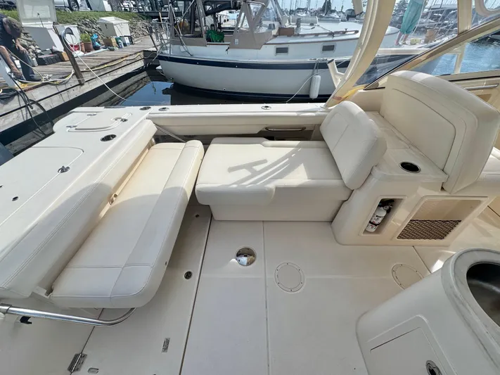 Bay Tripper Yacht Photos Pics 2019 Grady-White Freedom 307 boat interior with beige seating and storage compartments.