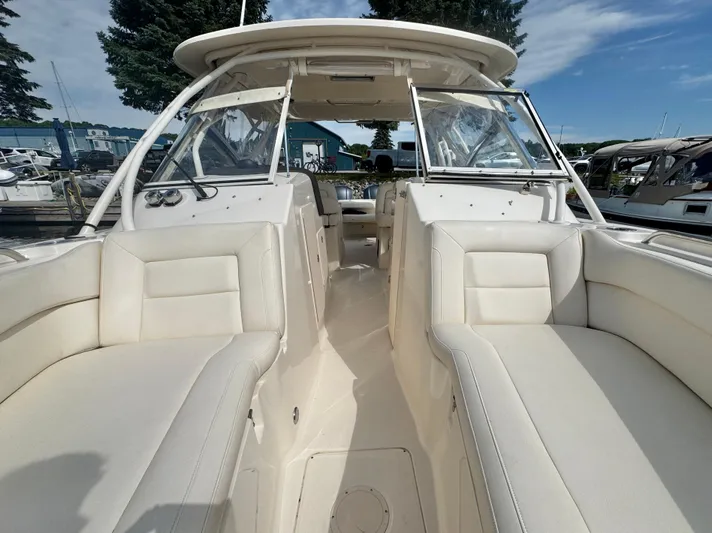 Bay Tripper Yacht Photos Pics 2019 Grady-White Freedom 307 boat interior with white seating and open cockpit.