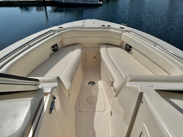 Bay Tripper Yacht Photos Pics 2019 Grady-White Freedom 307 boat interior with cushioned seating and water view.