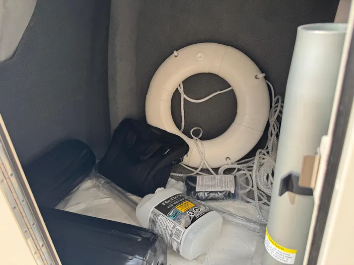 Bay Tripper Yacht Photos Pics Storage compartment of 2019 Grady-White Freedom 307 with life ring, ropes, and safety gear.
